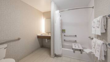 A modern bathroom with a walk-in shower, a toilet, a sink, and a towel rack.