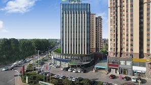 A hotel with a modern design, featuring a prominent sign for Holiday Inn Express.