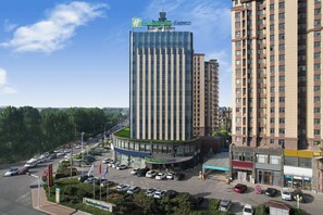 A hotel with a modern design, featuring a prominent sign for Holiday Inn Express. - Holiday Inn Express Linyi West by IHG (Linyi)