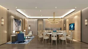 A modern dining area with a chandelier, round table, and chairs.