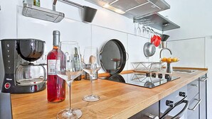 A modern kitchen with a coffee maker, wine glasses, and a wine bottle. - Vacation home Ravan by Interhome (Motovun)