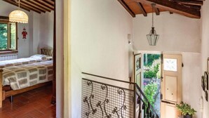 A bedroom with a bed, a window, and a wooden ceiling. - La Ripresa by Interhome (Vicchio)