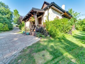 A rustic house with a stone pathway leading to a wooden porch. - Bastrówka by Interhome (Krakow)