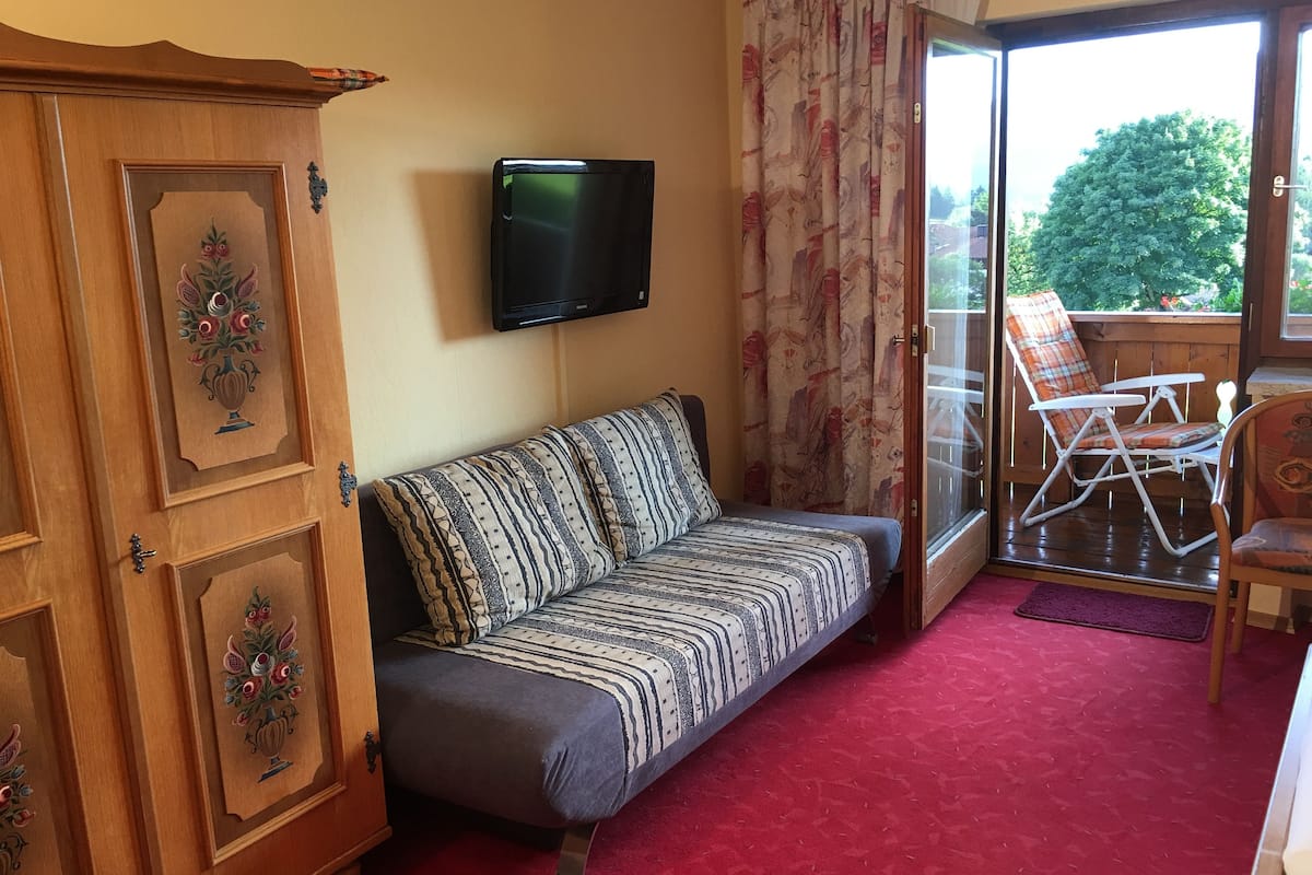 Triple Room, Balcony | Living area