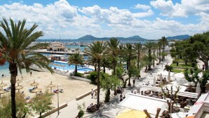 A coastal resort with a beach, palm trees, and a marina. - Can Niu by Interhome (Pollença)