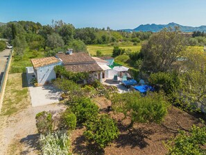 A villa with a tiled roof, a swimming pool, and a garden. - Can Niu by Interhome (Pollença)