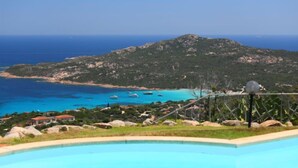 A pool with a view of a coastal landscape, including a mountain and boats on the water. - Paradiso by Interhome (Porto Cervo)