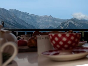 A table with a coffee setup and a view of mountains. - Vacation home Bivak by Interhome (Nendaz)