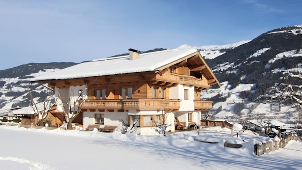 A wooden chalet with a balcony, surrounded by snow-covered mountains. - Gasteighof by Interhome (Fügen)