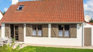 A two-story house with a red-tiled roof, a satellite dish, and a small window. - Vissershuisje 213 with parking by Interhome (Bredene)