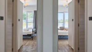 A hotel room with a bed, a small table with a tray of breakfast, and a balcony with a view. - Vacation home La Mer by Interhome (Pula)