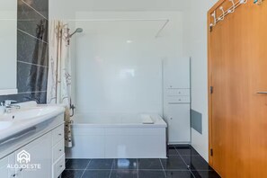 Bathtub, hair dryer, bidet, towels