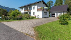 A two-story house with a balcony, a garage, and a paved driveway. - Apartment Pacher by Interhome (Gallizien)