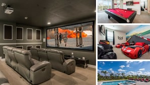 A home entertainment room with a large screen, comfortable seating, and a ceiling-mounted projector.