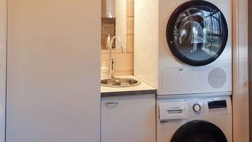 A compact laundry area with a Bosch washing machine and dryer stacked on top of each other.