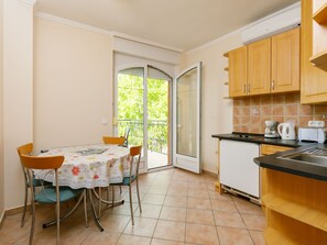 Fridge, microwave, cookware/dishes/utensils, dining tables