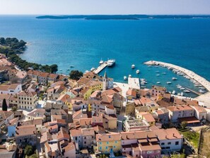 A coastal town with colorful buildings, a marina, and boats.