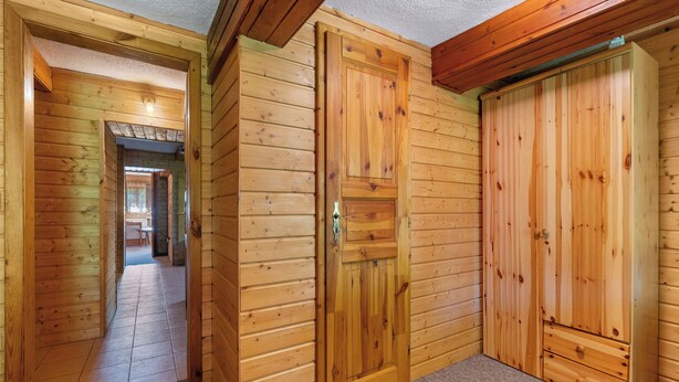 A wooden interior with a hallway leading to a dining area. - Lenora I by Interhome (Lenora)