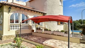 A house with a tiled roof, a balcony with a railing, and a red umbrella. - Somnium Mare by Interhome (Dénia)