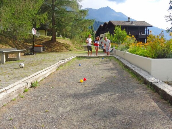 Enjoy a leisurely game of croquet amidst lush greenery and mountain views.