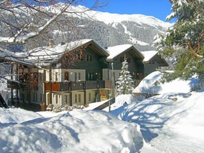 Experience the rustic charm of this traditional chalet, featuring a central entrance and symmetrical facade.