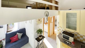 Un apartamento de dos pisos con sala de estar, comedor y cocina.