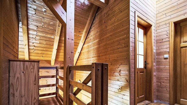 A wooden interior with a wooden door, a wooden gate, and a wooden cabinet. - Sluneční vršek by Interhome (Kořenov)