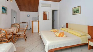 A bedroom with a bed, a desk, a chair, and a small table. - Martina by Interhome (Hvar/Pokrivenik)
