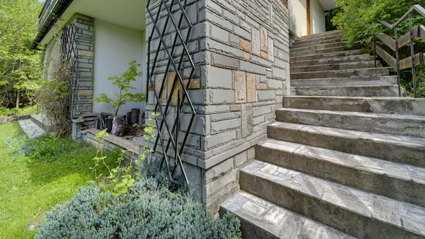 A stone staircase leading to a house with a white exterior and a metal railing. - Partecznik by Interhome (Wisla)