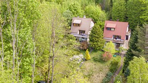 Two houses surrounded by dense forest, with a visible pathway leading to the houses. - Partecznik by Interhome (Wisla)