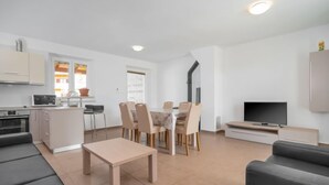 A modern apartment with a living room, dining area, kitchen, and a TV. - Mario 2 by Interhome (Pula/Krnica)