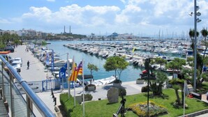 A marina with numerous boats docked, a pedestrian walkway, and a clear sky. - Gambaner by Interhome (Alcúdia)