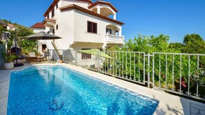 A two-story house with a swimming pool, a balcony, and a garden. - Antoine by Interhome (Marina)