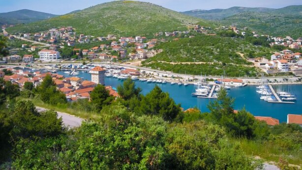 A coastal town with a marina, houses, and hills in the background. - Antoine by Interhome (Marina)