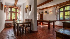 A room with a pool table, wooden chairs, a dining table, and a billiards table. - Osada Ulnowo by Interhome (Grunwald)