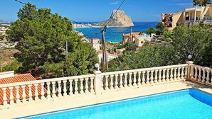 A swimming pool with a view of a rocky coastline and buildings in the background. - Vista Ifach by Interhome (Calpe/Calp)