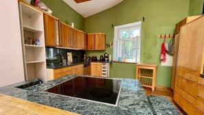 A kitchen with wooden cabinets, a granite countertop, and a built-in stove.