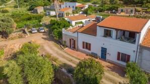 A residential area with houses featuring red-tiled roofs, surrounded by greenery and hills. - Camilla by Interhome (Valledoria)