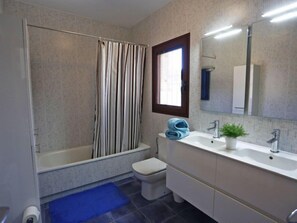 A modern bathroom with a shower, toilet, and sink. - Perales by Interhome (L'Ampolla)