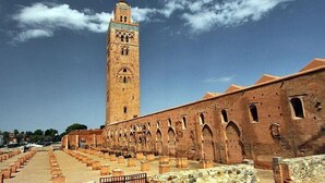 A historic building with a tall tower and arched windows. - Riad Drissia (Fes)