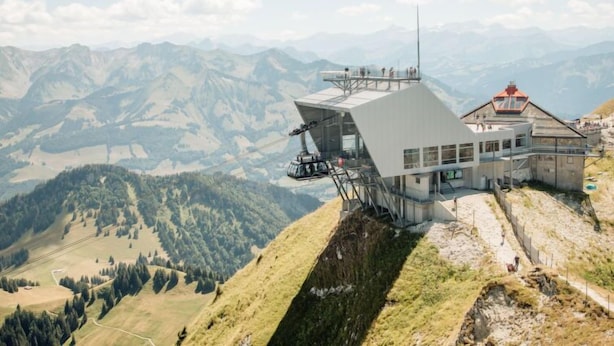 A mountain lodge with a modern design, featuring a large glass facade and a red-roofed observation tower. - Chalet La Poya by Interhome (Moléson-sur-Gruyères)