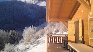A wooden cabin with a balcony overlooking a snowy mountain and forest. - Chalet La Poya by Interhome (Moléson-sur-Gruyères)