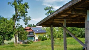 A house with a sloped roof, solar panels, and a wooden pergola structure. - Kleine Winten by Interhome (Geinberg)