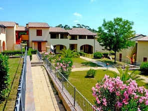 Residential complex with two-story houses and well-manicured lawns.