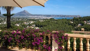 A balcony with a view of a coastal town, a mountain, and a clear blue sky. - Bellevue by Interhome (Jávea)