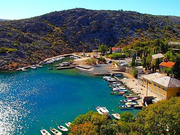 A coastal village with a marina, boats, and houses.