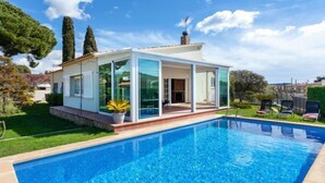 A modern house with a swimming pool, large glass windows, and a patio area. - Amsterdam by Interhome (St Antoni de Calonge)