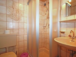 A bathroom with a shower, toilet, and sink. - Untererhof by Interhome (Fügen)