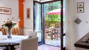 A dining area with a table, chairs, and a view of the outdoors. - Apartment Mariza by Interhome (Labin)