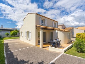 A two-story house with a patio area, a small garden, and a clear sky. - Brive 1 by Interhome (Vaux Sur Mer)
